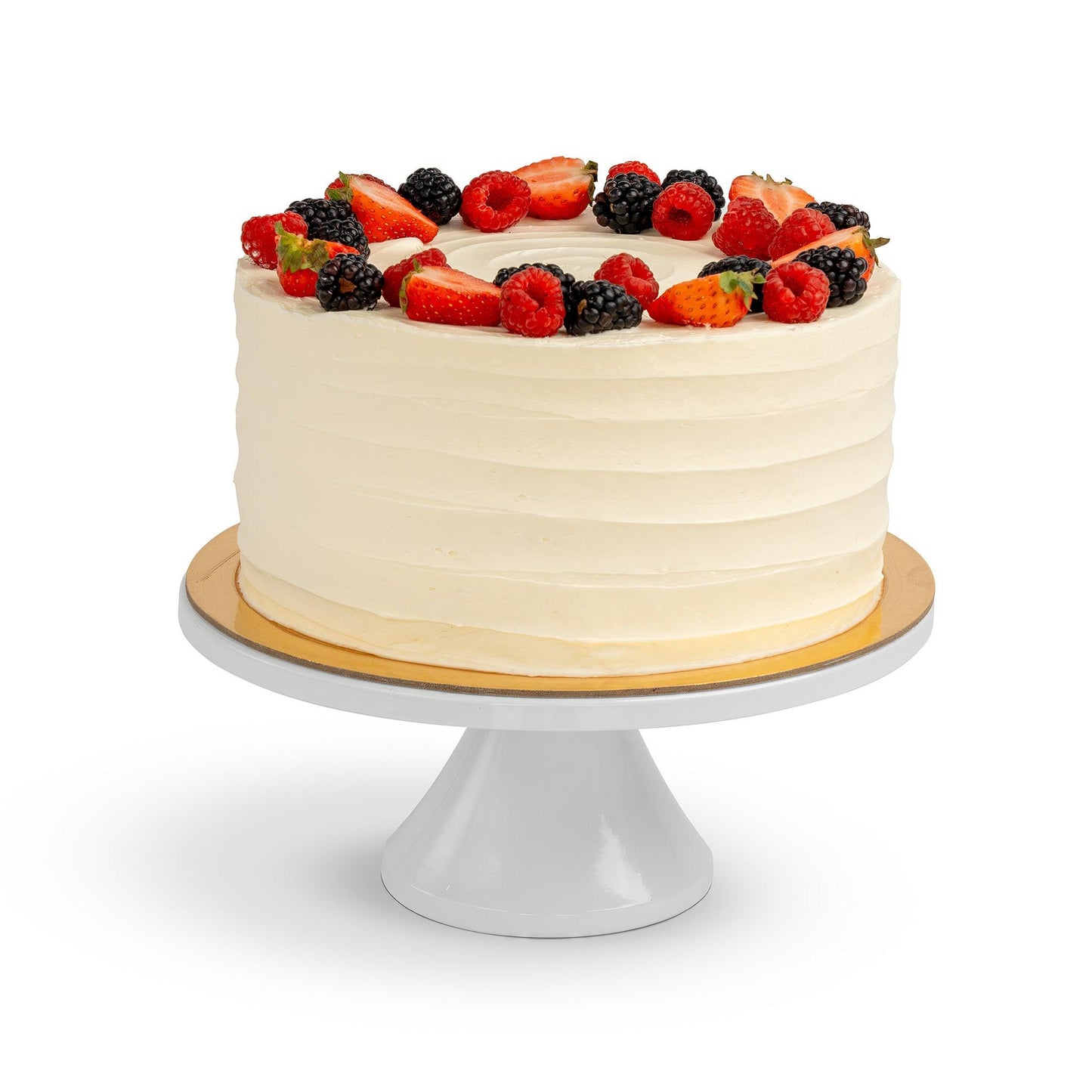 A beautifully frosted Berry Cake, topped with a generous arrangement of fresh strawberries, raspberries, and blackberries, displayed on a white cake stand.