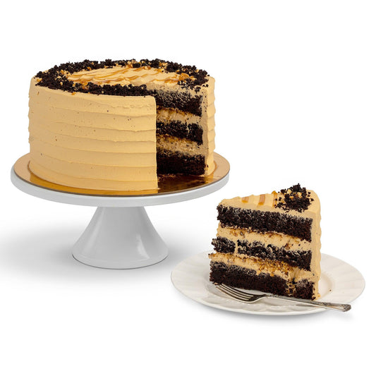 A Choco-Crunchy Hazelnut Cake with a slice removed, showcasing layers of moist chocolate cake, hazelnut frosting, and crunchy chocolate crumbles, served on a plate.