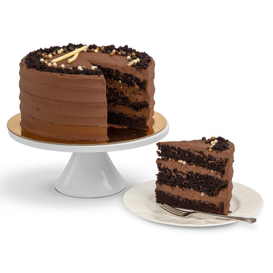 A Choco-Nutella Cake with a slice removed, revealing layers of moist chocolate cake and Nutella frosting, garnished with chocolate crumbles and pearls, served on a plate.