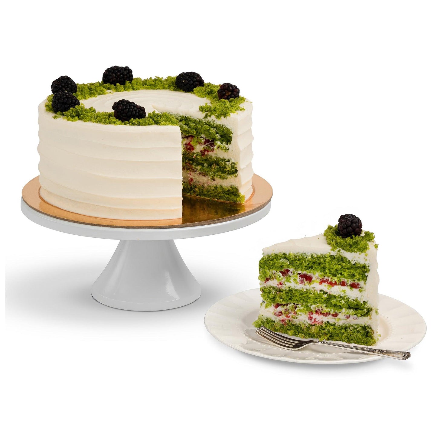 A Spinach Cake with a slice removed, showcasing fluffy green spinach layers, cream frosting, and fresh berry accents, served on a plate.