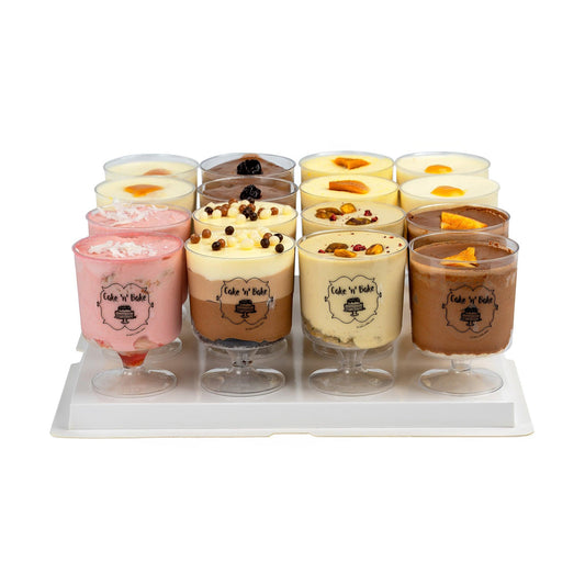 A variety of mousse desserts in a gift box featuring 16 servings: Pistachio Matcha Raspberry, Tropical, Triple Chocolate, Orange Hazelnut, Chocolate Cherry, Banana Coconut, Raspberry Cream, and Mango, elegantly presented in clear cups with the Cake N’ Bake logo.